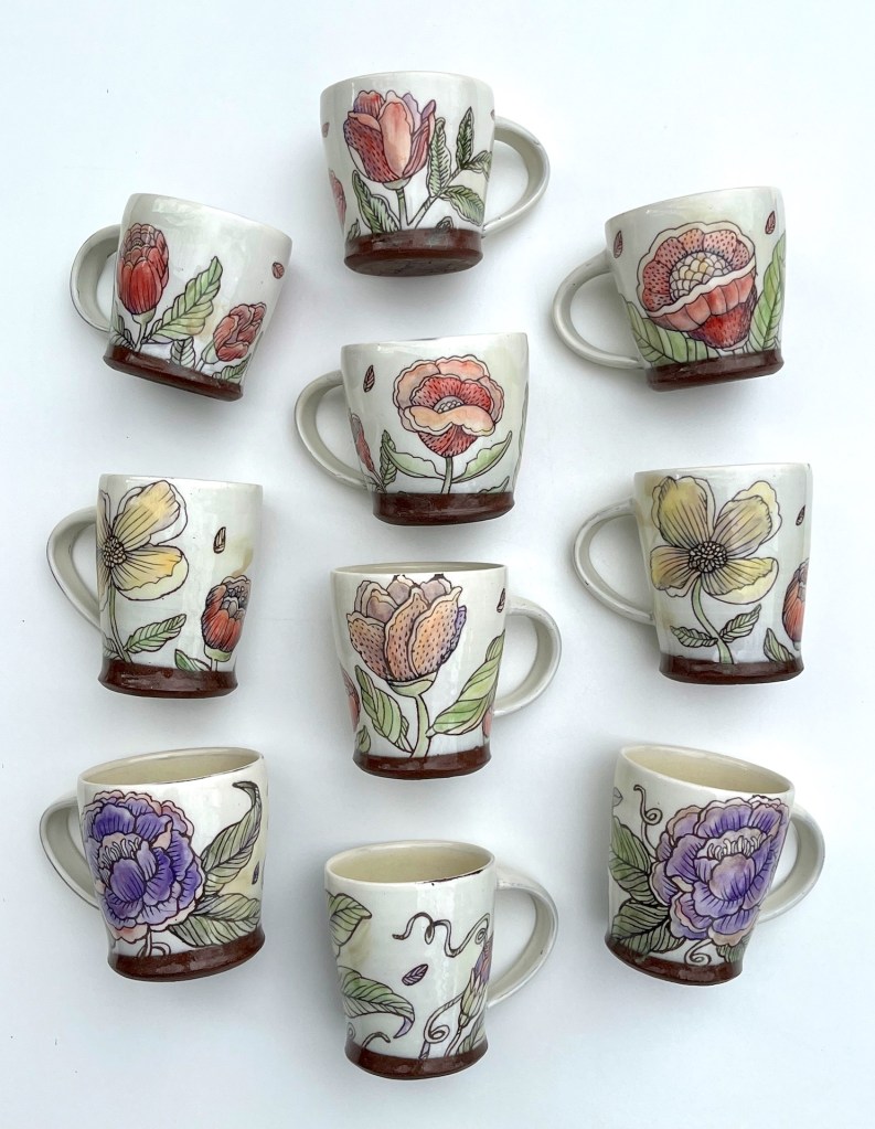 Ceramic mug with white glazed backgrounds and floral designs